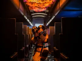 Firefighters putting out fire in an airplane simulation