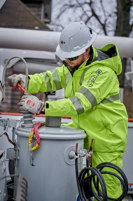 Electrical utility worker performing a routine maintenance task.