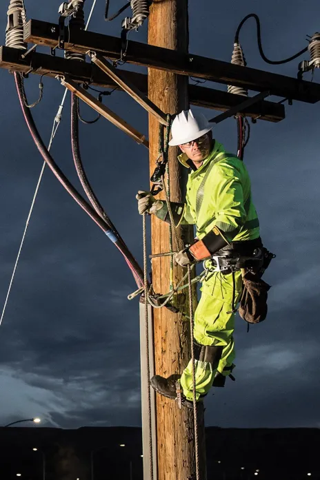 Electrical utility worker performing a highly demanding task.