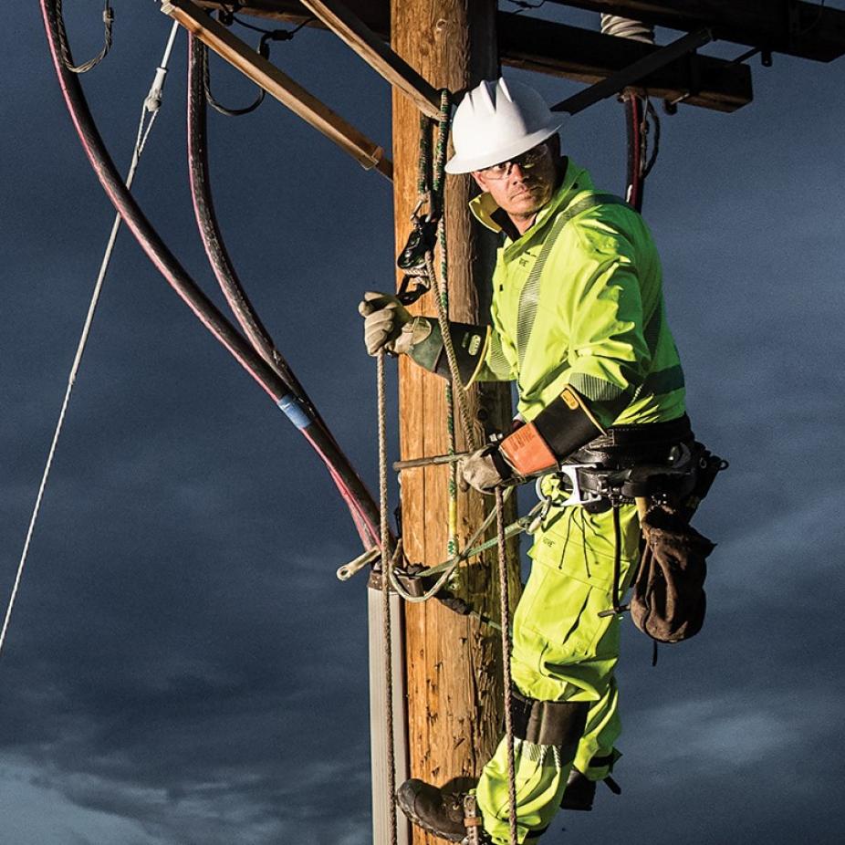 Electrical utility worker performing a highly demanding task.​